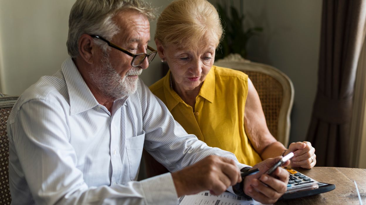 Two older couple looking at cost Two older couple looking at cost