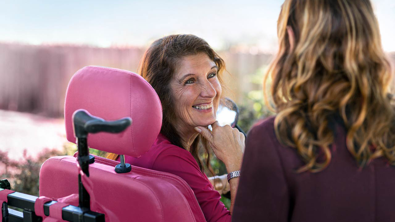 Smiling woman with a disability sitting in a wheelchair