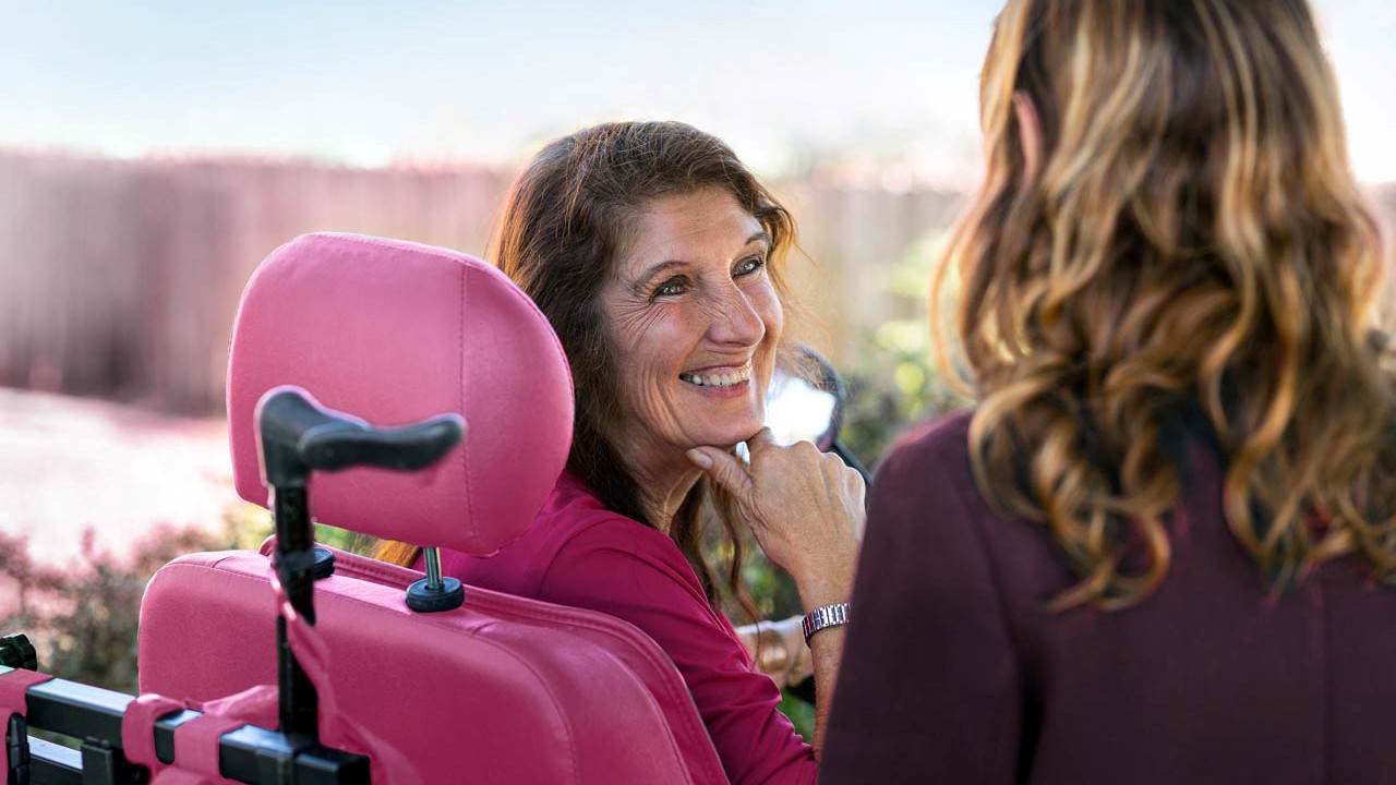 Smiling woman with a disability sitting in a wheelchair Smiling woman with a disability sitting in a wheelchair